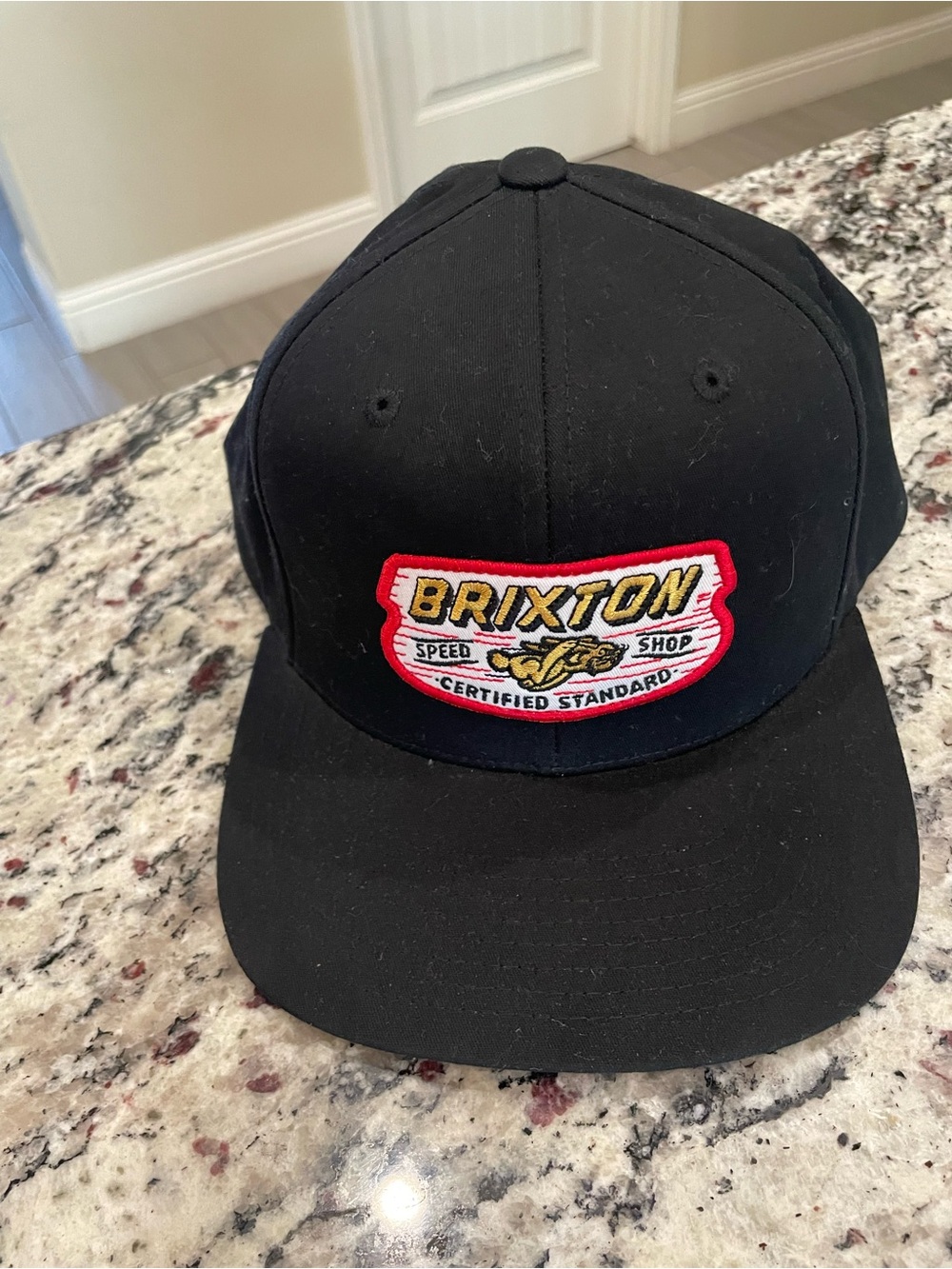 Brixton Black Snapback Hat with Red and Yellow Crest